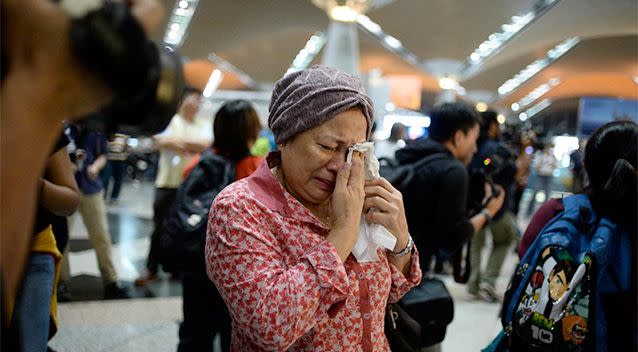 A woman reacts to news regarding a Malaysia Airlines plane that crashed in eastern Ukraine at Kuala Lumpur International Airport in Sepang, Malaysia. Photo: AP/Joshua Paul.