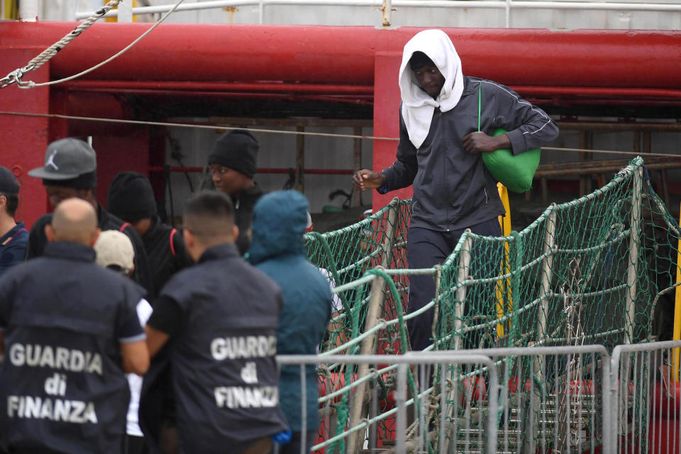 A migrant disembarks the Ocean Viking, docked at the Sicilian port of Messina, southern Italy, Tuesday, Sept. 24, 2019. The humanitarian ship has docked in Sicily, Italy, to disembark 182 men, women and children rescued in the Mediterranean Sea after fleeing Libya. (Carmelo Imbesi/ANSA via AP)