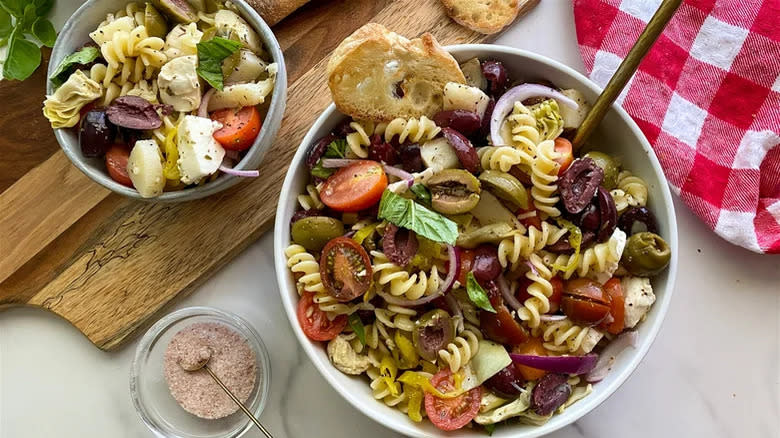 Veggie antipasti pasta salad in two white bowls