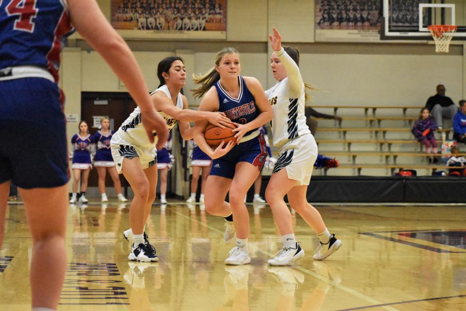 Martinsville's Holly Galyan fights for possession with Mooresville's Emma McGinley and Sydney Hardy during the Artesians' sectional battle with the Pioneers on Feb. 3, 2023.