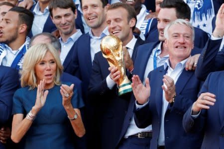 FILE PHOTO: French President Emmanuel Macron and his wife Brigitte Macron pose with France soccer team captain Hugo Lloris and coach Didier Deschamps and players before a reception to honour the France soccer team after their victory in the 2018 Russia Soccer World Cup, at the Elysee Palace in Paris, France, July 16, 2018.   REUTERS/Philippe Wojazer