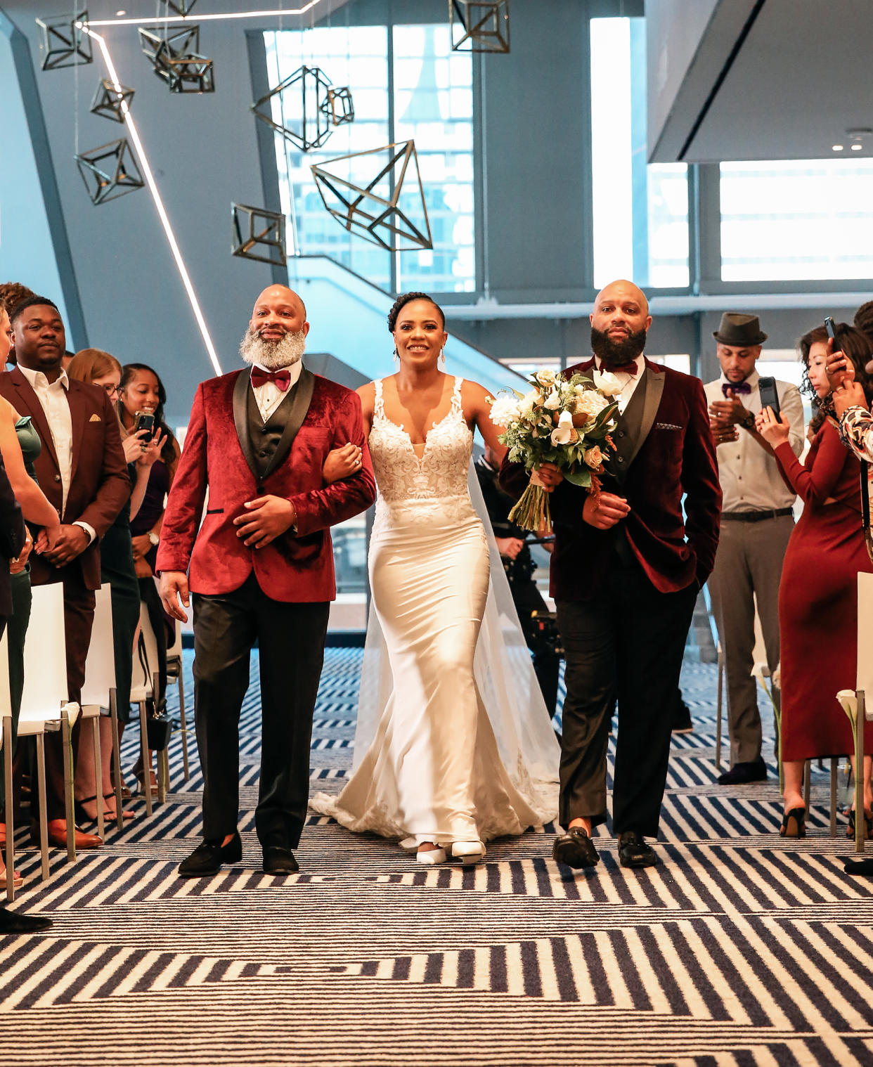 Ashleigh walks down the aisle with her brothers. (Felisha Carrasco and Christian Galvan)