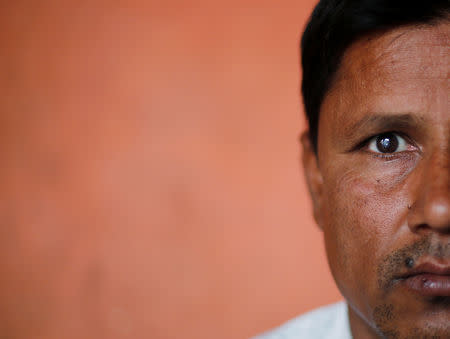 FILE PHOTO: Sharfuddin, a cloth shop owner, poses for a picture inside his house in Nayabans village in the northern state of Uttar Pradesh, India May 10, 2019. REUTERS/Adnan Abidi
