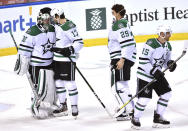 Dallas Stars goaltender Anton Khudobin (35) is congratulated by Nick Caamano (17) and teammates following a win over the Florida Panthers in an NHL hockey game Wednesday, Feb. 24, 2021, in Sunrise, Fla. (AP Photo/Jim Rassol)