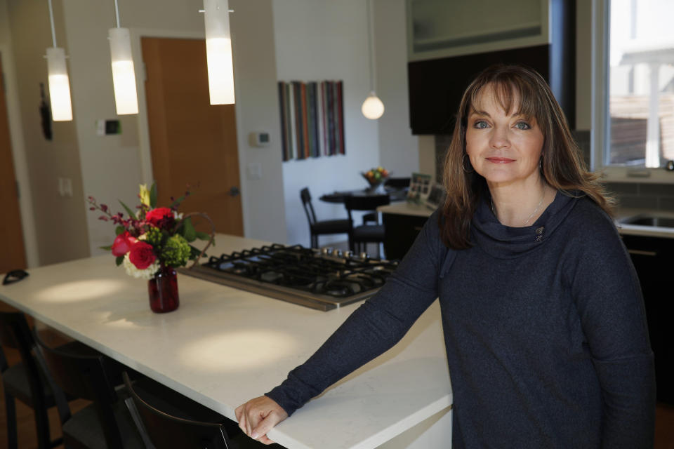 Coni Sanders, whose father was a teacher killed in the 1999 shooting at Columbine High School, poses for a photo at her home Saturday, March 16, 2019, in Denver. A growing movement is urging news organizations to avoid naming the gunmen responsible for mass shootings. The idea is to avoid inspiring more shooters who seek infamy and notoriety. "The media was so fascinated, and so was our country and the world, that they really grasped onto this every detail. Time and time again, we couldn’t escape it," Sanders said. (AP Photo/David Zalubowski)