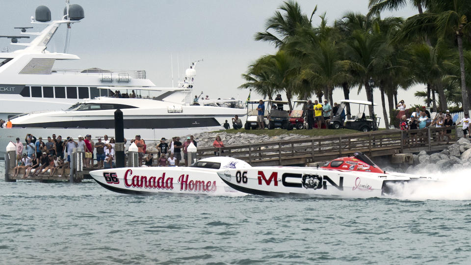 In this photo provided by the Florida Keys News Bureau, M-Con chases down Canada Homes during the second day of racing Friday, Nov. 12, 2021, at the Race World Offshore Key West Championships in Key West, Fla. M-Con's driver Myrick Coil of Osage Beach, Missouri, and throttleman Tyler Miller of Wathena, Kansas, surged ahead in the seventh lap Friday after trailing Canada Homes for more than half the race. M-Con has a significant lead in the Super Cat class ahead of the final race of the three-race series on Sunday, Nov. 14. Canada Homes, throttled by Miami's John Tomlinson and driven by Lorne Leibel of Toronto, is in second place. (Rob O'Neal/Florida Keys News Bureau via AP)