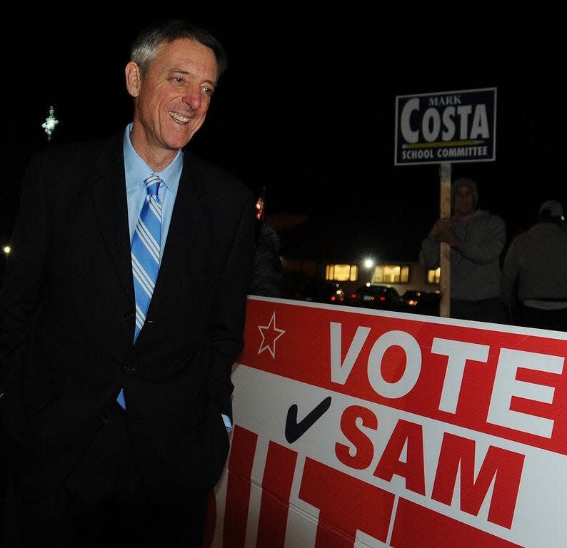 Then-Mayor Sam Sutter chats with people holding signs for his campaign outside Calvary Temple in Fall River in 2015.