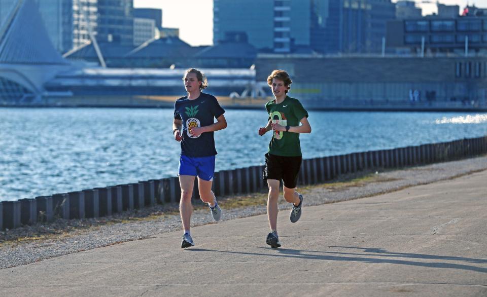 Joggers run along Lake Michigan in Milwaukee.