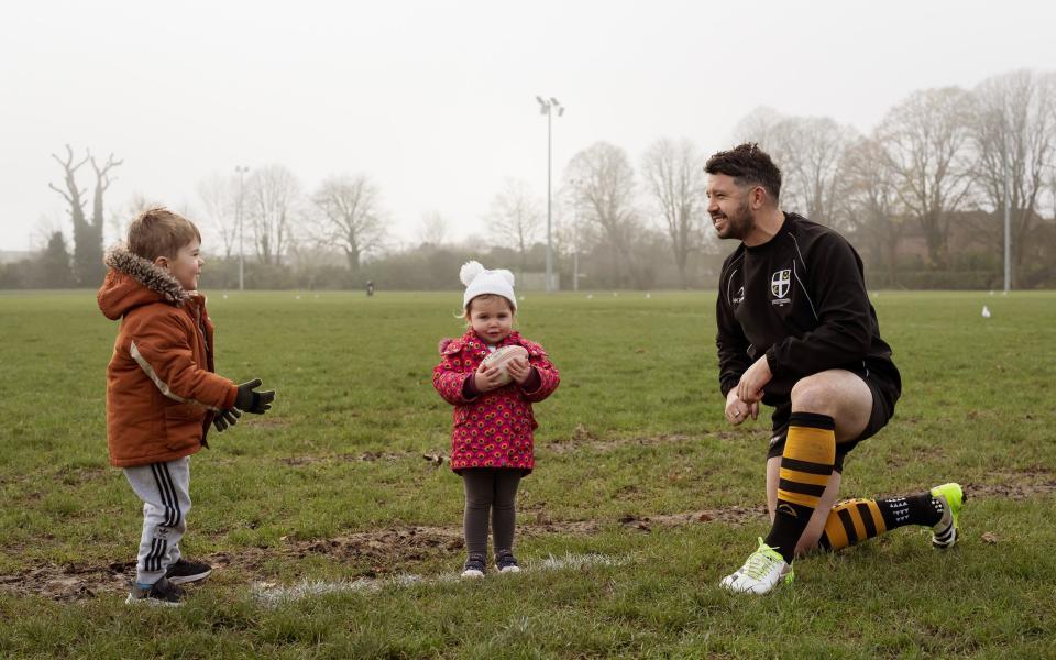 Gareth Davies with his two children on a rugby pitch