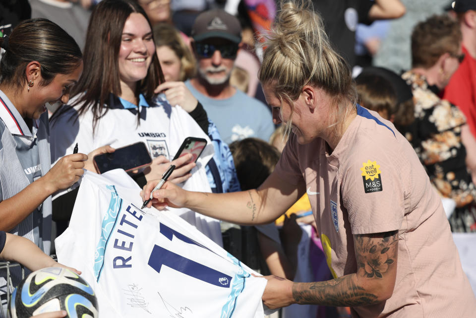 England's defender Millie Bright signs autographs for fans at Central Coast Stadium in Gosford, Australia, Tuesday, July 25, 2023. England ranks second only to the United States in Women's World Cup ticket sales for countries outside of Australia and New Zealand. (AP Photo/Jessica Gratigny)