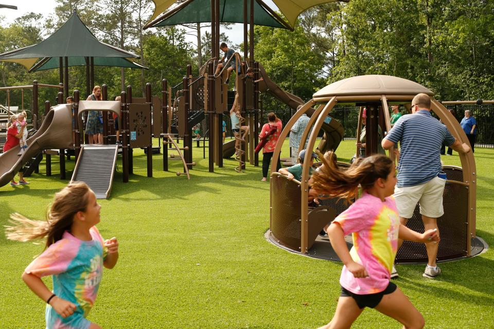 Kids play at Extra Special People's new fully accessible playground during the grand opening of ESP's Miracle League Complex in Watkinsville, Ga., on Monday, June 6, 2022. The complex is home to a Miracle League field and the only fully accessible playground in the Athens/Oconee area.