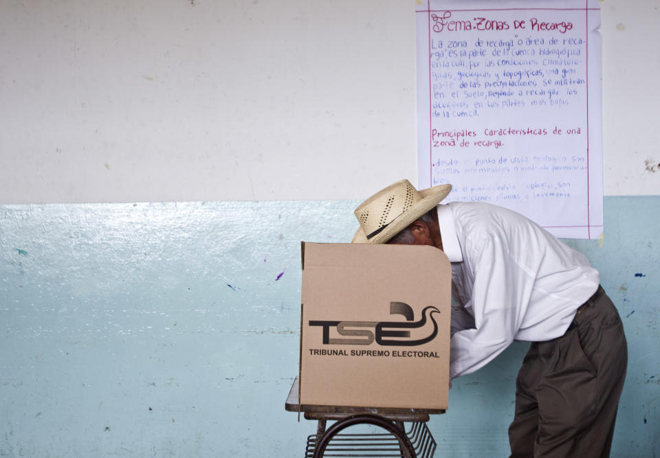 A man votes at a polling station during the presidential runoff election in Panchimalco, on the outskirts of San Salvador, El Salvador, Sunday, March 9, 2014. Salvadorans head to the polls Sunday to elect their next president in a runoff between former Marxist guerrilla Salvador Sanchez Ceren from the ruling Farabundo Marti National Liberation Front (FMLN), and former San Salvador Mayor Norman Quijano from the Nationalist Republican Alliance (ARENA). (AP Photo/Esteban Felix)