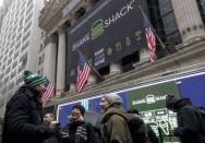 Patrons receive free breakfast from Shake Shack in front of New York Stock Exchange to celebrate the company's IPO January 30, 2015. REUTERS/Brendan McDermid