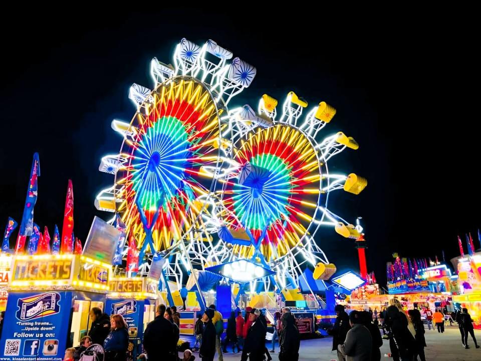 Ferris wheels glow at the Bluegrass Fair in Lexington, Kentucky.