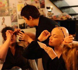 putting on false eyelashes