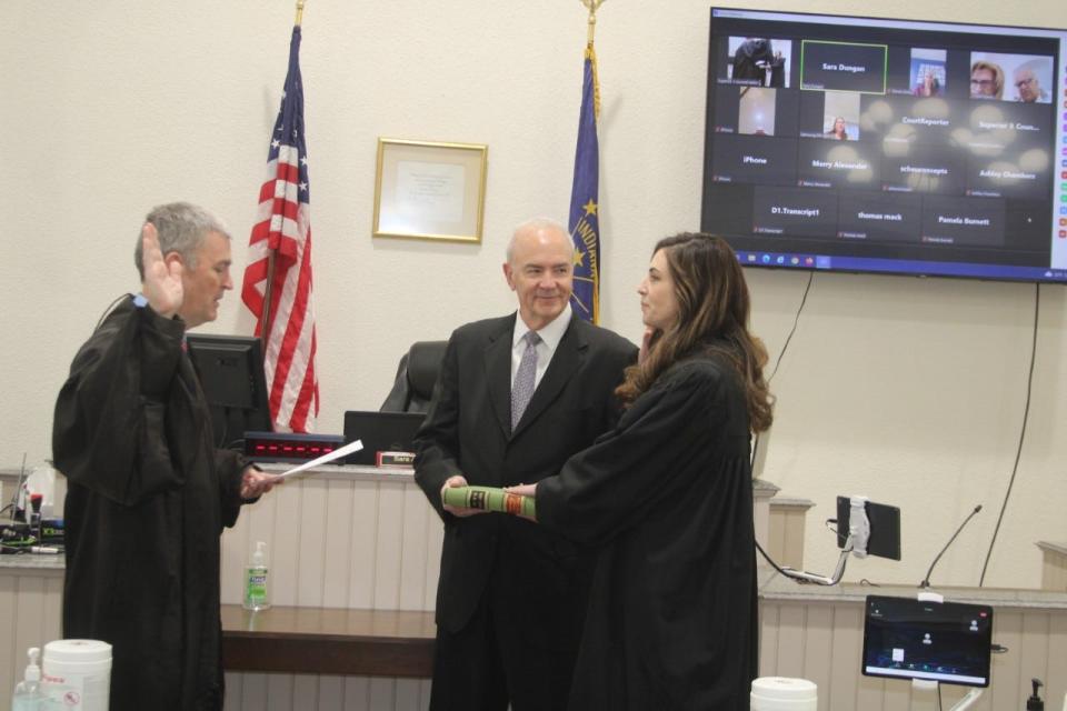 Morgan County Circuit Court Judge Matthew Hanson swears in Dakota VanLeeuwen as the new superior court I judge. VanLeeuwen's father, Stephen Scheu holds the Bible for his daughter.