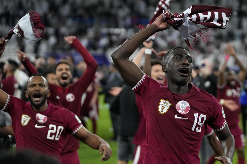 Qatar's Almoez Ali, right, celebrates with teammates after winning the match during the Asian Cup semifinal soccer match between Qatar and Iran at Al Thumama Stadium in Doha, Qatar, Wednesday, Feb. 7, 2024. (AP Photo/Thanassis Stavrakis)