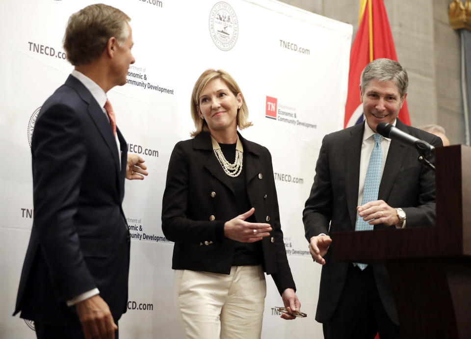 Holly Sullivan, center, of Amazon Public Policy, takes part in an announcement about Amazon's decision to locate an operations hub in Nashville , Tenn., Tuesday, Nov. 13, 2018, with Tennessee Gov. Bill Haslam, left, and Economic and Community Development Commissioner Bob Rolfe, right. The $230 million-plus investment will make Nashville the eastern U.S. hub for Amazon's retail operations division. The investment will be the single largest jobs commitment made by a company in the state's history. (AP Photo/Mark Humphrey)