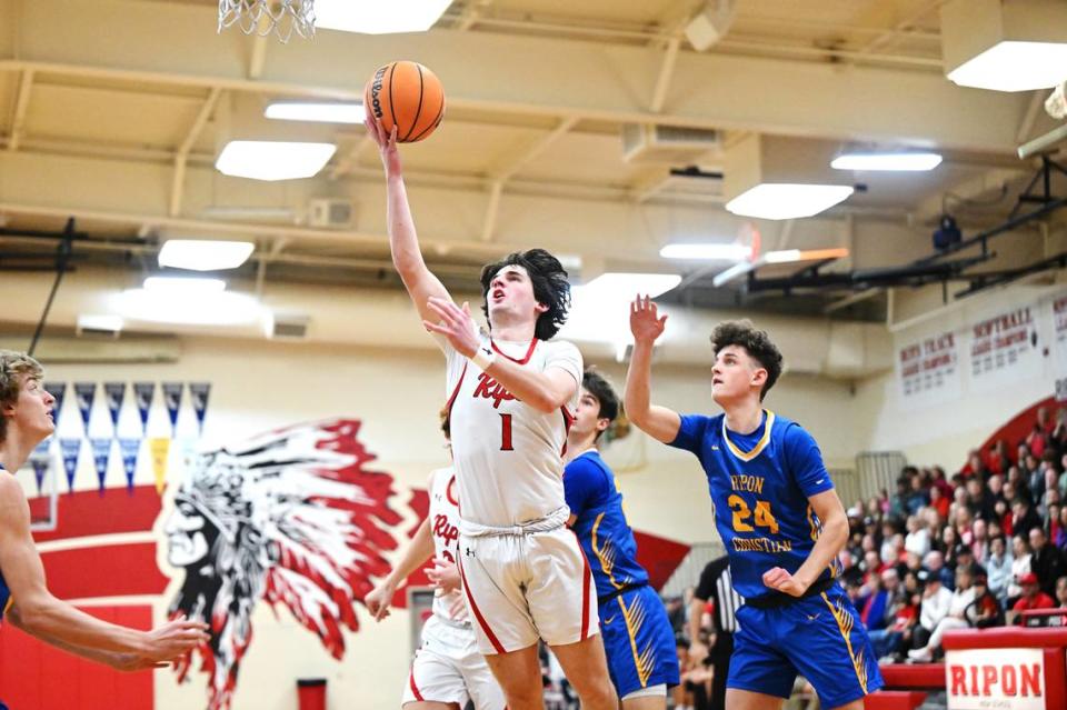 Ripon’s Landon Gillespie scores past Ripon Christian’s Jake Vander Veen during the Trans Valley League game in Ripon, Calif., Friday, Feb. 9, 2024.