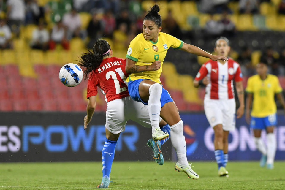 Maria Martinez of Paraguay competes for the ball with Debinha of Brazil during the Women's CONMEBOL Copa America 2022 Semi Final match between Brazil and Paraguay at Estadio Alfonso Lopez on July 26, 2022 in Bucaramanga, Colombia.<span class="copyright">Gabriel Aponte—Getty Images</span>