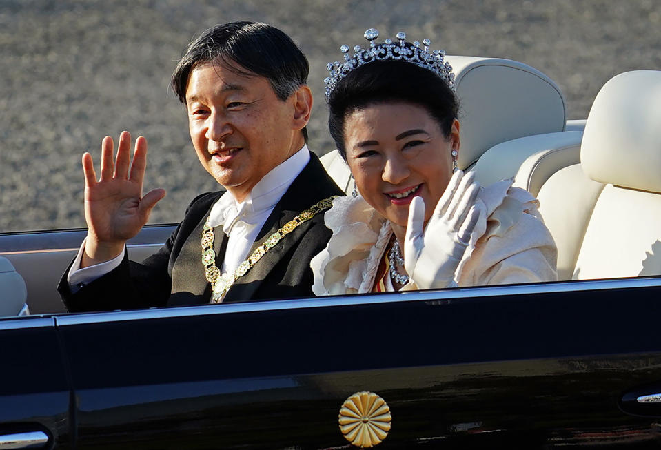 FILE - In this Nov. 10, 2019, file photo, Japan's Emperor Naruhito, left, and Empress Masako, wave during the royal motorcade in Tokyo. Emperor Naruhito later this week will perform his first harvest ritual since ascending to the Chrysanthemum Throne. It’s called Daijosai, or great thanksgiving festival, the most important imperial ritual that an emperor performs only once in his reign.(AP Photo/Eugene Hoshiko, File)