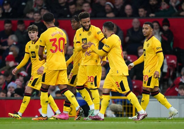 Jayden Bogle (centre) celebrates the opening goal 