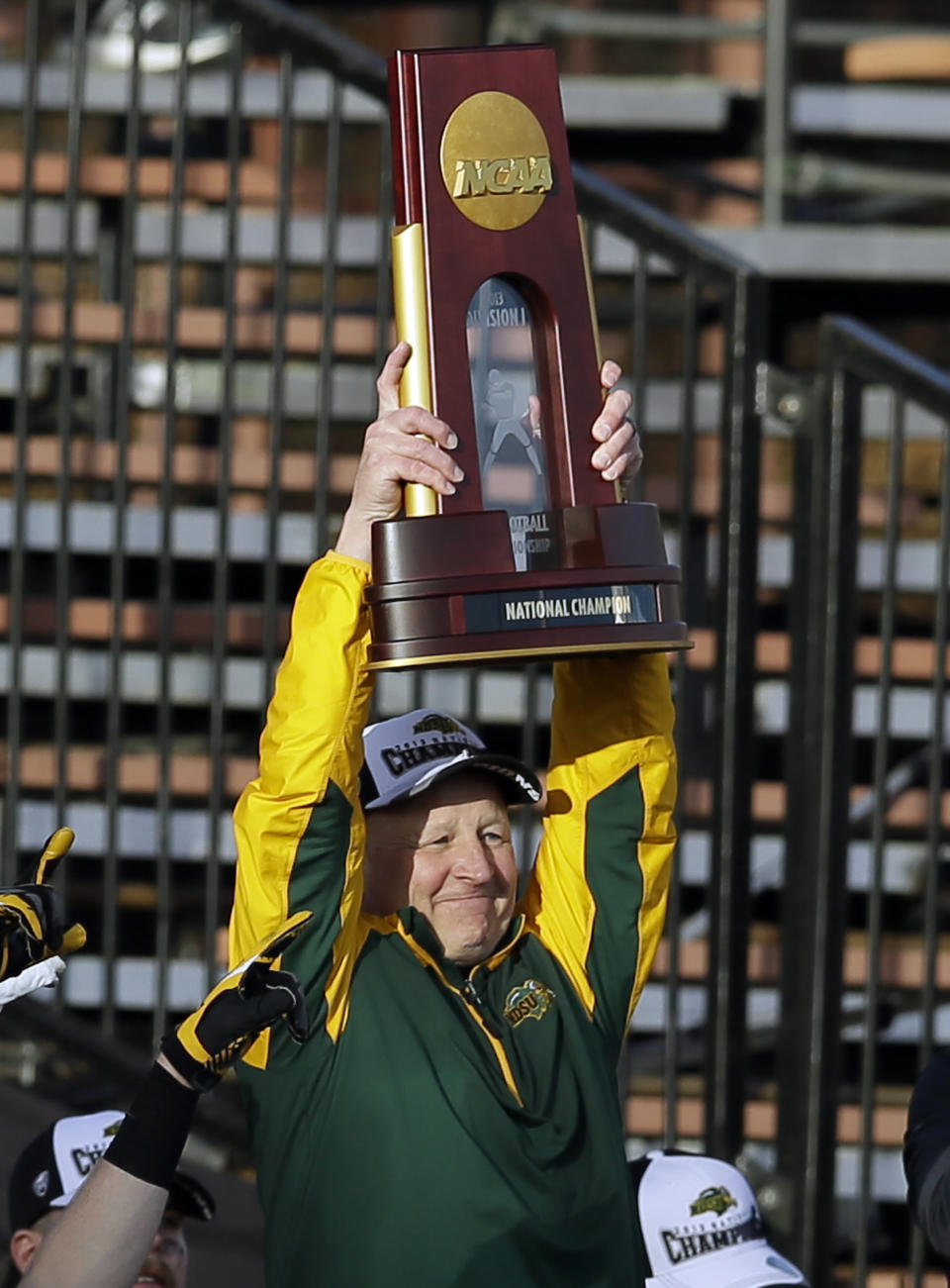 North Dakota State head coach Craig Bohl holds up the trophy as he celebrates winning the FCS championship NCAA college football game against Towson, Saturday, Jan. 4, 2014, in Frisco, Texas. NDSU won 35-7. (AP Photo/Tony Gutierrez)