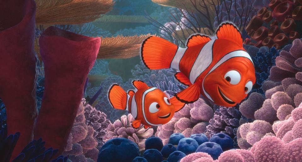 Marlin and Nemo, clownfish characters from the animated film "Finding Nemo," swim through a colorful coral reef