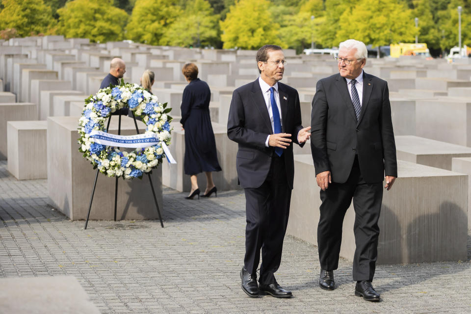 Israeli President Isaac Herzog, left, and German President Frank-Walter Steinmeier, right, attend a wreath laying ceremony at the Holocaust memorial in Berlin, Germany, Tuesday, Sept. 6, 2022. (AP Photo/Christoph Soeder)