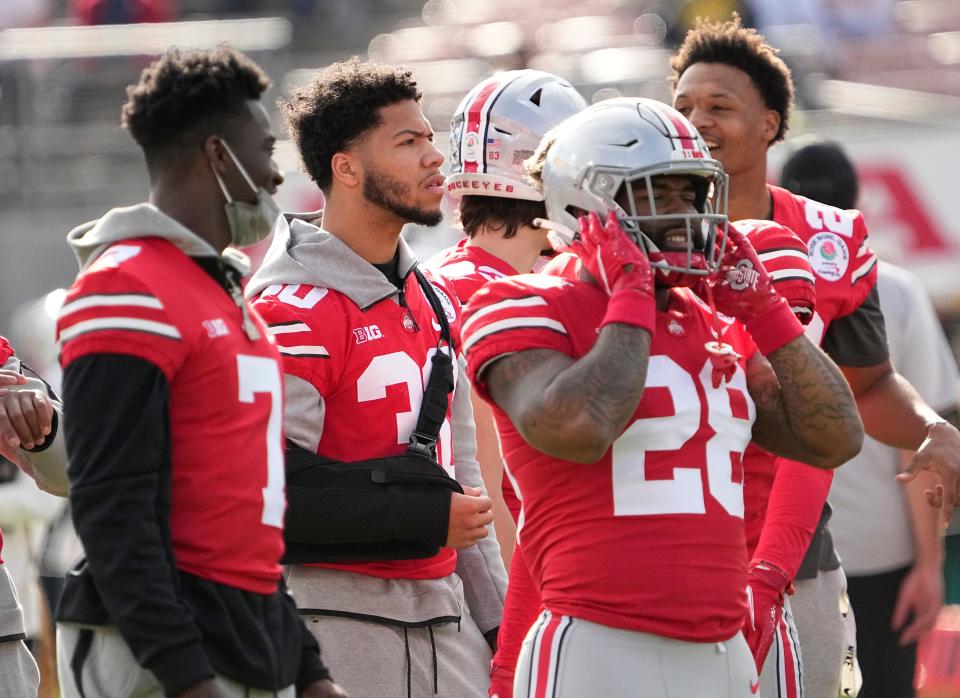 Ohio State linebacker Cody Simon, with his arm in a sling at the Rose Bowl following shoulder surgery, pronounced himself healthy as the Buckeyes' training camp continues.