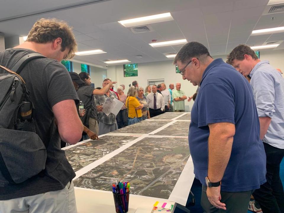 Residents look over a map of the proposed Red Line and offer feedback to CATS staff at a community meeting on the project in Huntersville Thursday.