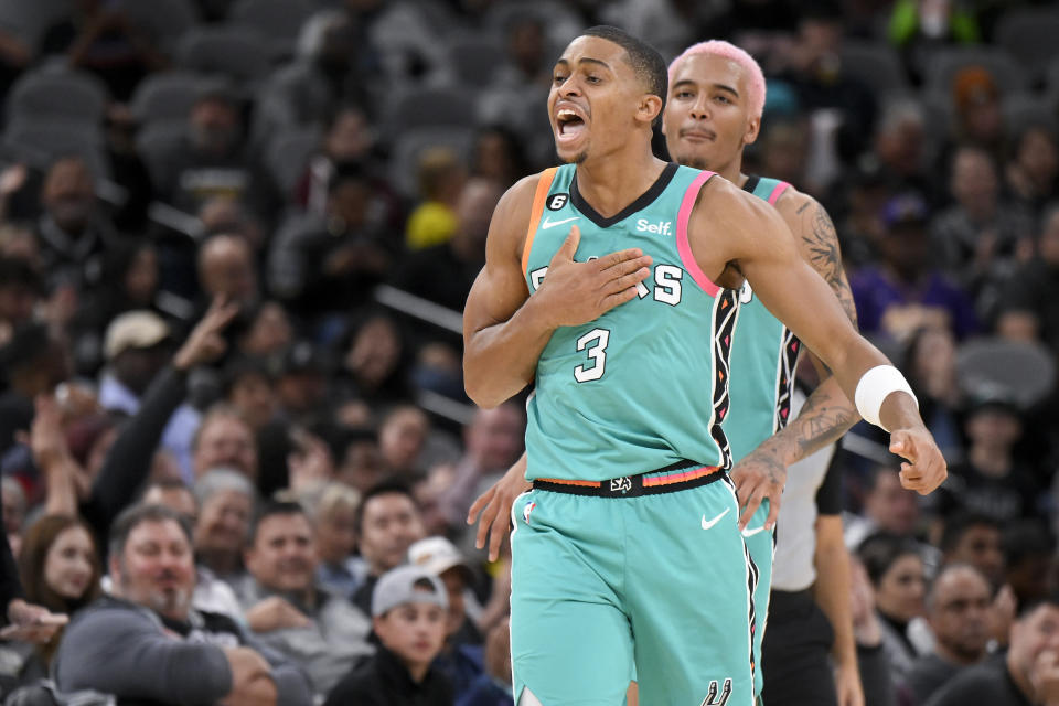 San Antonio Spurs' Keldon Johnson (3) celebrates a three-point basket with teammate Jeremy Sochan during the second half of an NBA basketball game against the Milwaukee Bucks, Friday, Nov. 11, 2022, in San Antonio. San Antonio won 111-93. (AP Photo/Darren Abate)