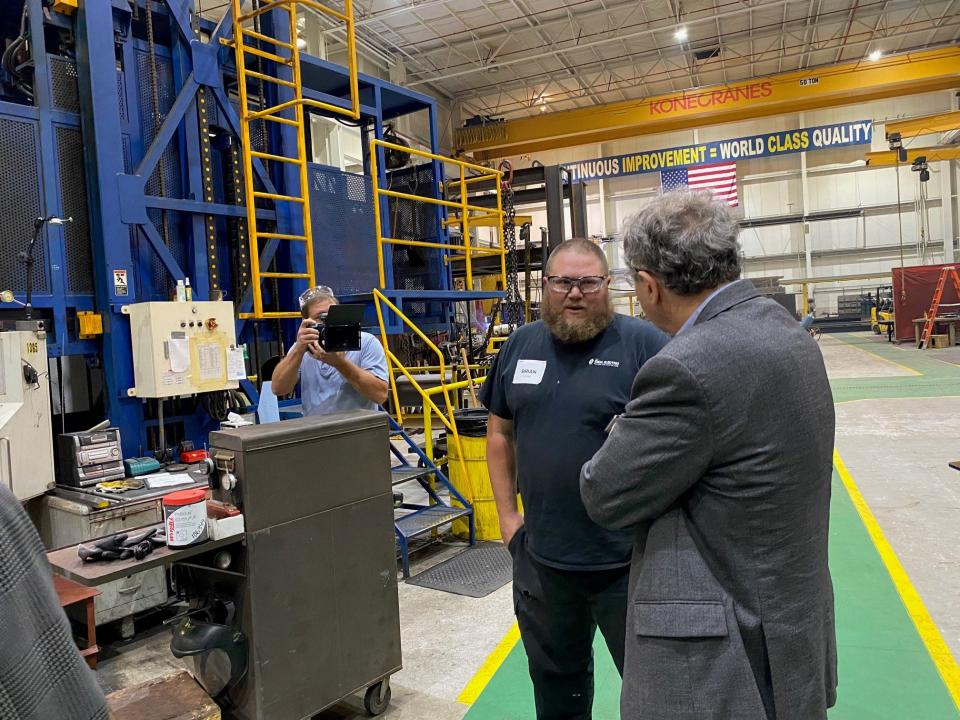 Sen. Sherrod Brown, at right, talks with Brian Lowe, a CNC operator at the Ideal Electric Company, 330 E. First St., Friday afternoon while touring the business in Brown's hometown.