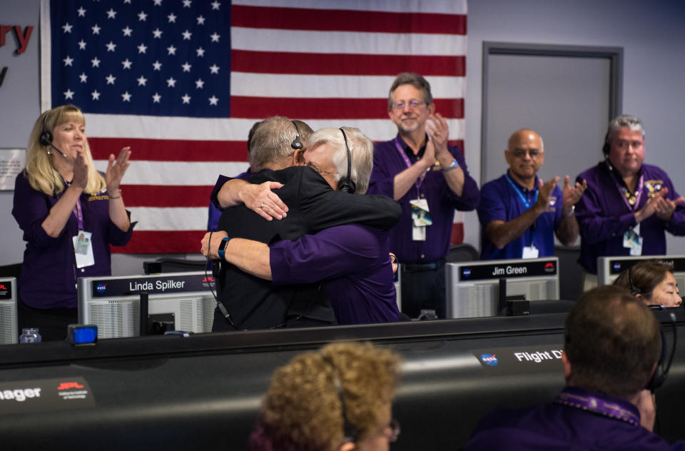 <p>Cassini program manager at JPL, Earl Maize, left, and spacecraft operations team manager for the Cassini mission at Saturn, Julie Webster embrace after the Cassini spacecraft plunged into Saturn, Friday, Sept. 15, 2017 at NASA’s Jet Propulsion Laboratory in Pasadena, Calif. Since its arrival in 2004, the Cassini-Huygens mission has been a discovery machine, revolutionizing our knowledge of the Saturn system and captivating us with data and images never before obtained with such detail and clarity. On Sept. 15, 2017, operators deliberately plunged the spacecraft into Saturn, as Cassini gathered science until the end. The “plunge” ensures Saturn’s moons will remain pristine for future exploration. During Cassini’s final days, mission team members from all around the world gathered at NASA’s Jet Propulsion Laboratory, Pasadena, Calif., to celebrate the achievements of this historic mission. (Photo: NASA/Joel Kowsky) </p>