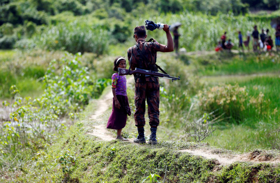 Image: A member of Border Guard Bangladesh (BGB) tells a Rohingya girl not to come on Bangladesh side, in Cox's Bazar (Mohammad Ponir Hossain / Reuters file)