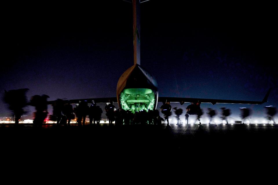 US Soldiers, assigned to the 82nd Airborne Division, prepare to board a U.S. Air Force C-17 Globemaster III aircraft to leave Hamid Karzai International Airport in Kabul, Afghanistan on Aug 30, 2021.