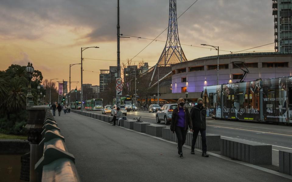 Pedestrians wearing masks walk along St Kilda Road on June 11, 2021 in Melbourne, Australia. Melbourne's lockdown measures were lifted as of 12:01 on Friday, although some COVID-19 restrictions remain in place as Victoria continues to record new coronavirus cases. Masks remain mandatory outdoors, while the five reasons to leave home will no longer apply.  - Getty Images