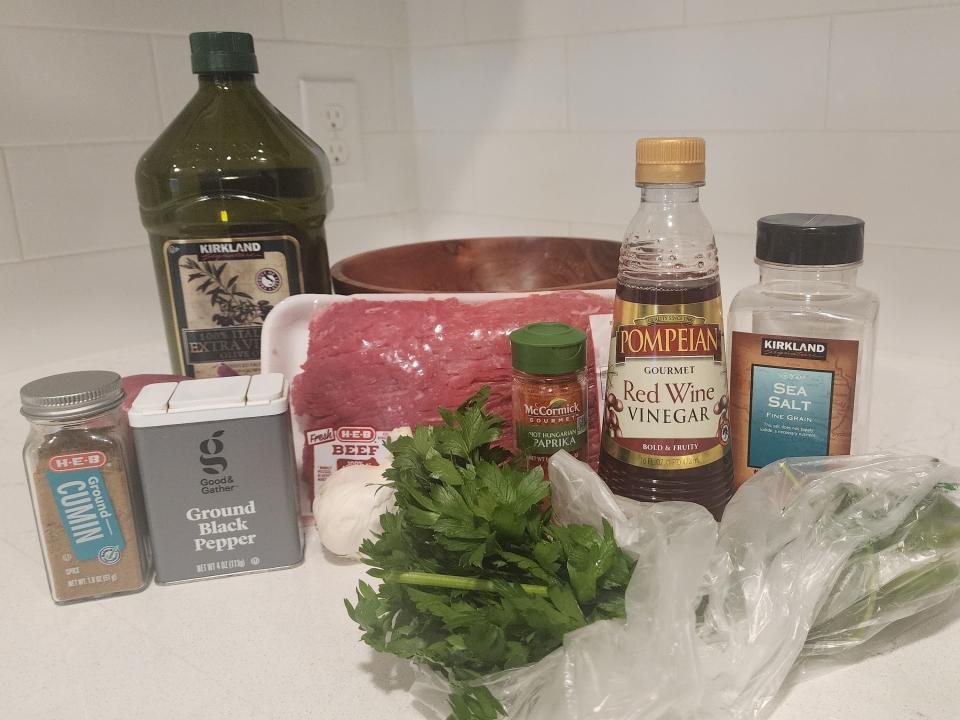 Steak ingredients including meat, vinegar, olive oil, and seasonings