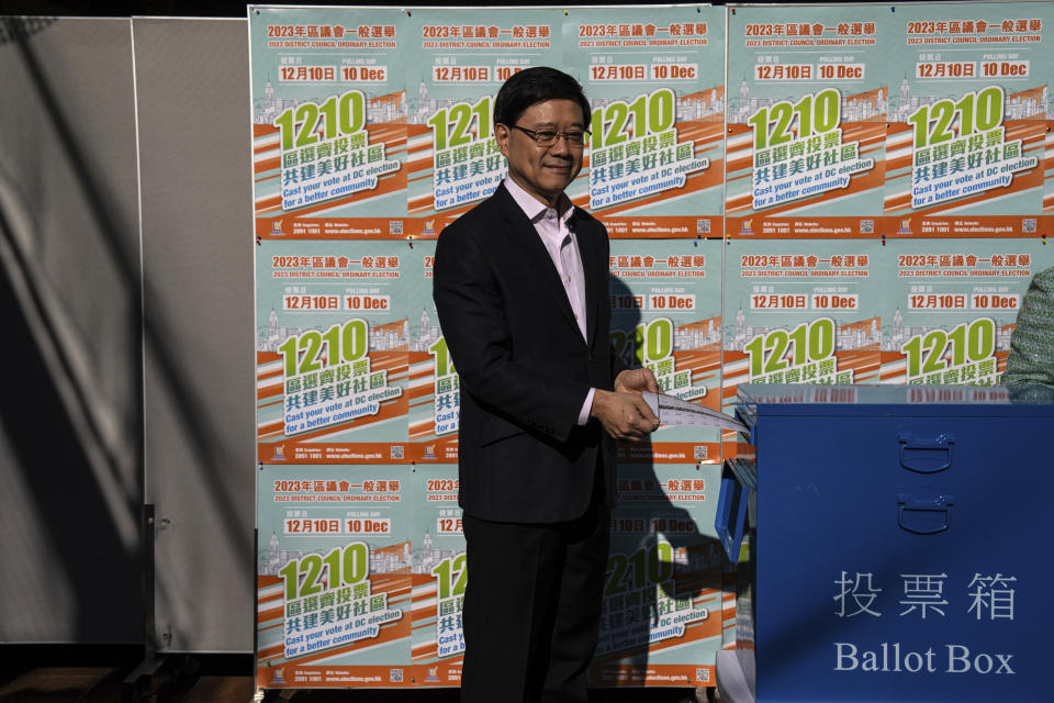 Hong Kong's Chief Executive John Lee casts his ballot at a polling station during the District Council elections in Hong Kong, Sunday, Dec. 10, 2023. Residents went to the polls on Sunday in Hong Kong's first district council elections since an electoral overhaul was implemented under Beijing's guidance of “patriots” administering the city, effectively shutting out all pro-democracy candidates.(AP Photo/Louise Delmotte)