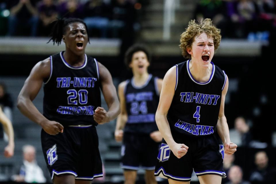 Wyoming Tri-unity Christian guard Keaton Blanker, right, and  forward Akais Giplaye celebrate a play against Frankfort during the first half of the Division 4 boys basketball semifinal at Breslin Center on Thursday, March 23, 2023.