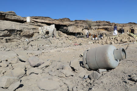 People gather at the site of an air strike near the northwestern city Saada, Yemen December 3, 2017. REUTERS/Naif Rahma