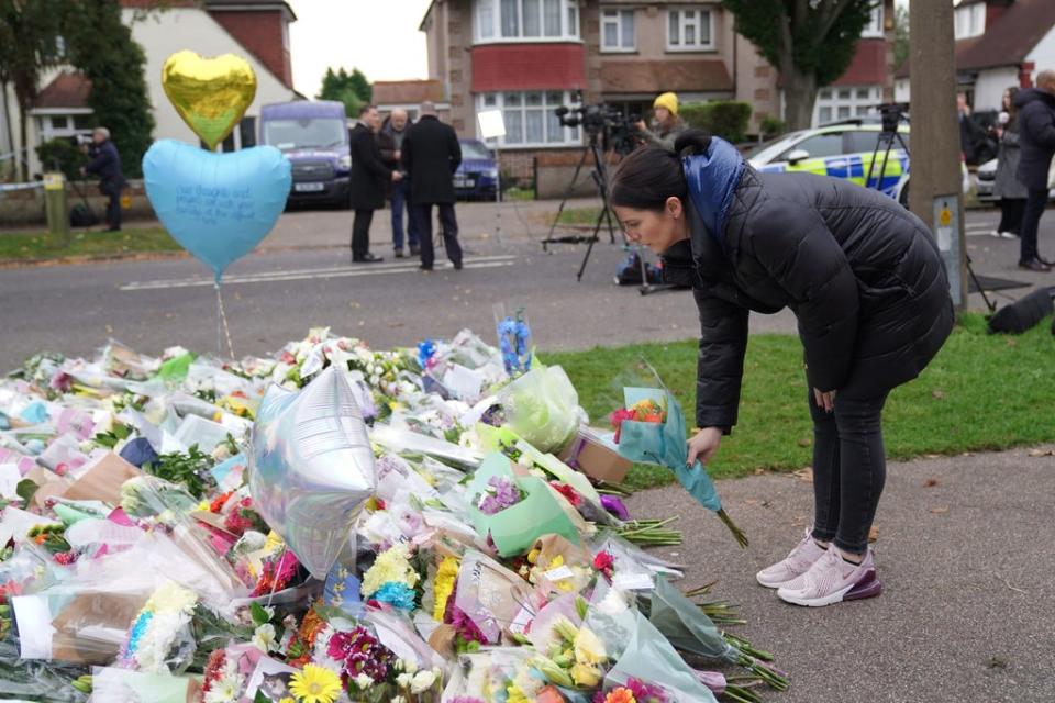 A woman lays flowers at the scene near Belfairs Methodist Church in Leigh-on-Sea (PA)