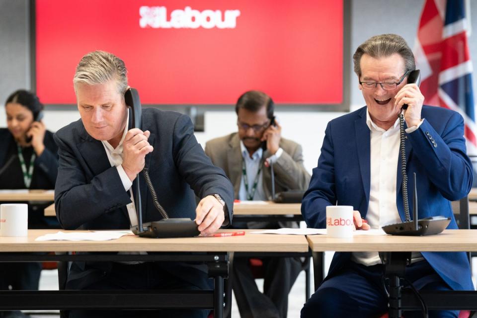 Labour leader Sir Keir Starmer (left) is joined by musician Feargal Sharkey canvassing voters by phone for the Wellingborough (PA)