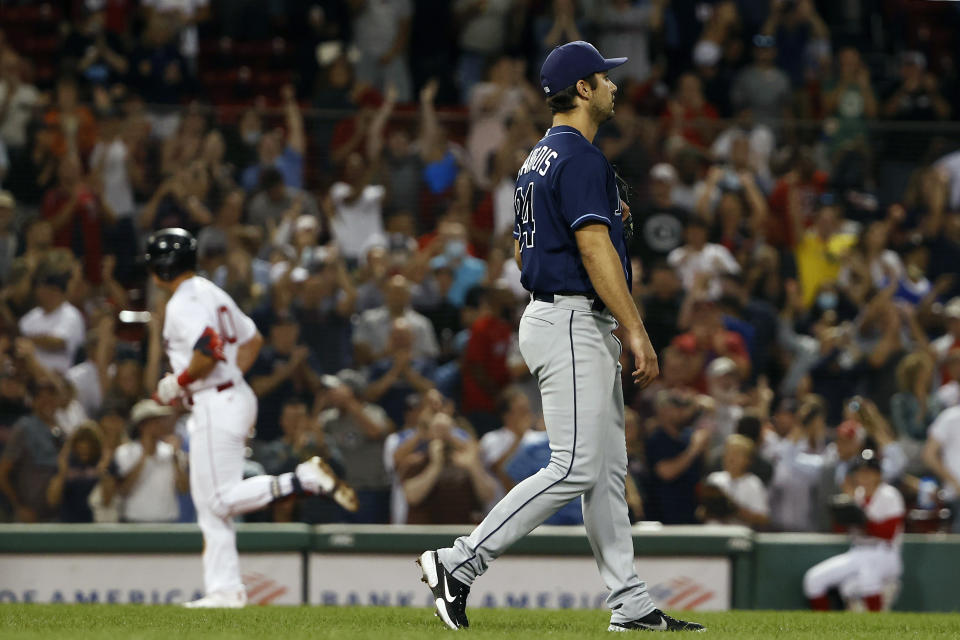 Tampa Bay Rays relief pitcher JT Chargois walks off the mound as Boston Red Sox's Hunter Renfroe circles the bases after his two run home run during the eighth inning of a baseball game Wednesday, Sept. 8, 2021, at Fenway Park in Boston. (AP Photo/Winslow Townson)