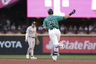 Seattle Mariners' Cal Raleigh (29) rounds the bases after hitting a solo home run as Oakland Athletics second baseman Max Schuemann, back left, looks on during the second inning of a baseball game, Saturday, May 11, 2024, in Seattle. (AP Photo/Jason Redmond)