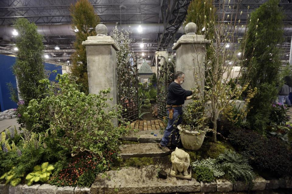 This feb. 28, 2013 photo shows Steve Eshelman with Stoney Bank Nurseries working on an installation in preparation for the annual Philadelphia Flower Show at the Pennsylvania Convention Center in Philadelphia. More than 270,000 people are expected to converge on the Pennsylvania Convention Center for the event, which runs through March 10. Billed as the world's largest indoor flower show, it's also one of the oldest, dating back to 1829. (AP Photo/Matt Rourke)