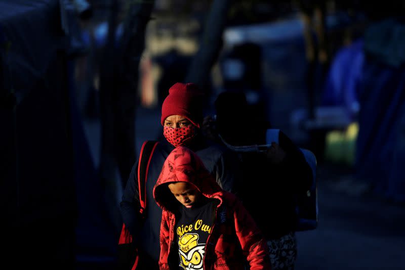 FILE PHOTO: Migrants who are seeking asylum in the U.S. are pictured at a migrant encampment in Matamoros