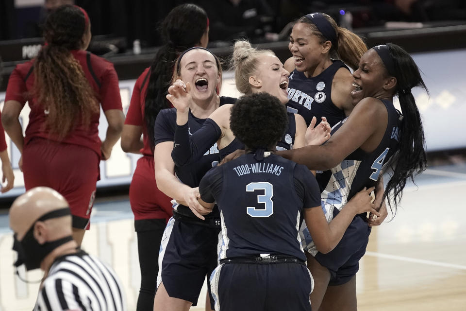 North Carolina players celebrate following a victory over North Carolina State in an NCAA college basketball game in Chapel Hill, N.C., Sunday, Feb. 7, 2021. (AP Photo/Gerry Broome)