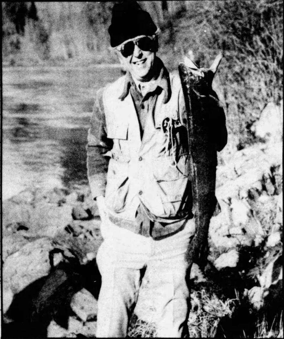 Oregon Supreme Court Justice Edwin J. Peterson holding up a steelhead he caught in a photograph accompanying a 1981 article published in the Statesman Journal.