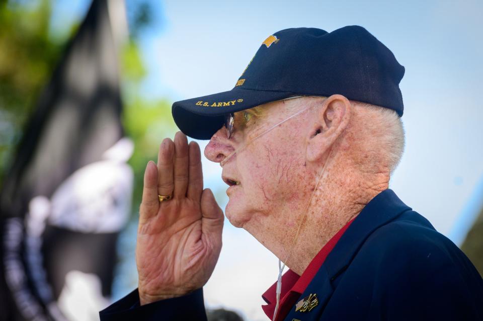 Retired Florida National Guard Sgt. Maj. Ray Quinn salutes the flag at the start of St. Augustine's annual Memorial Day Ceremony held at the St. Augustine National Cemetery on Monday, May 30, 2022.